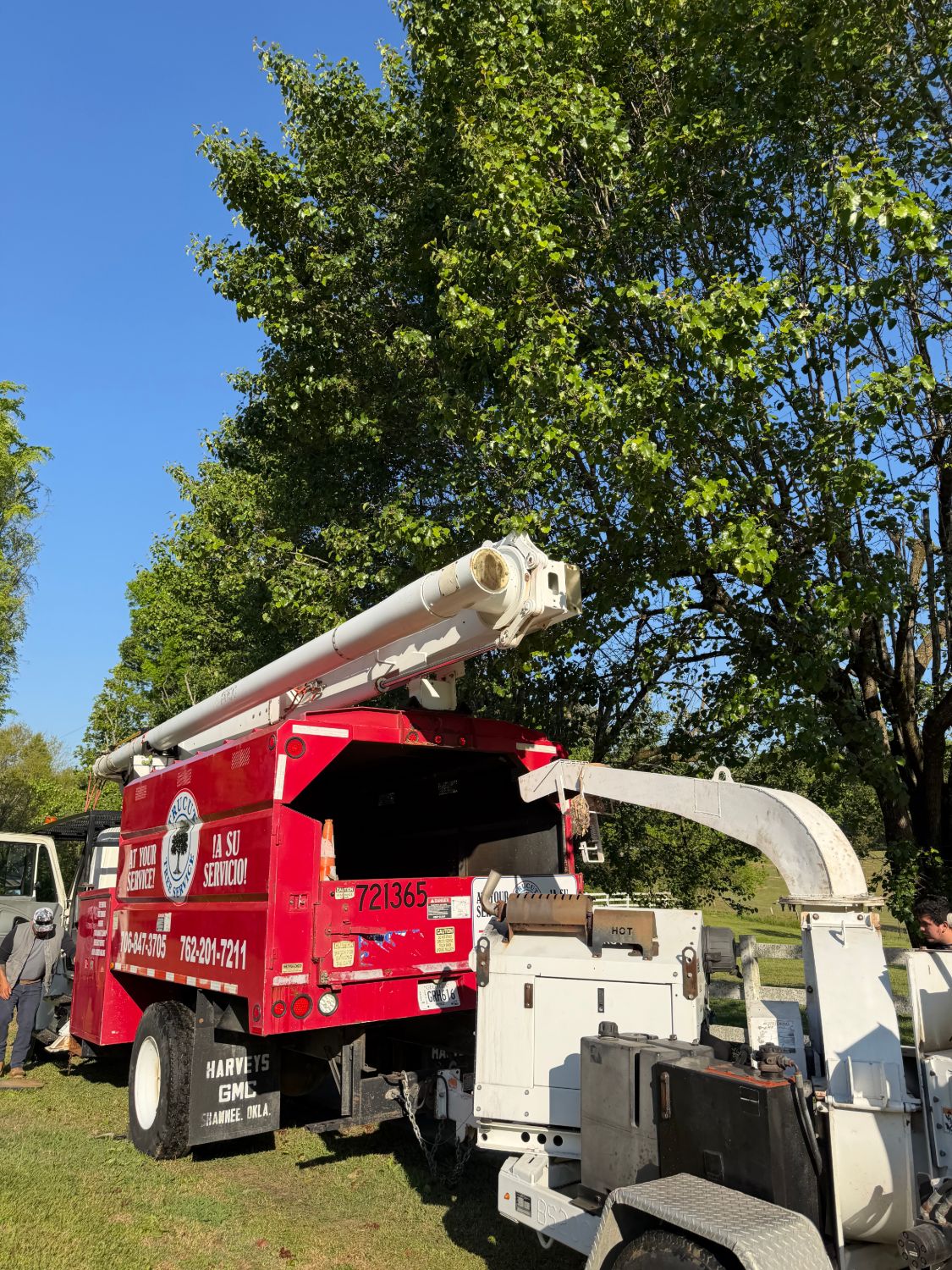 TruCut Tree Service bucket truck and wood chipper on a job site